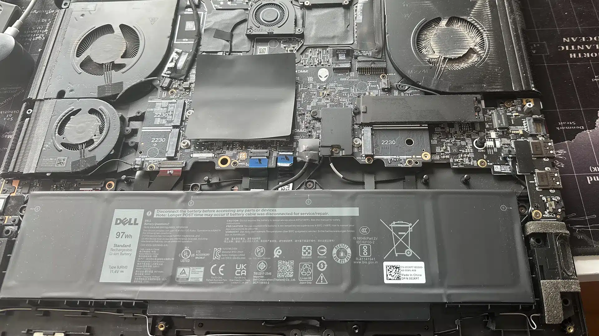 Laptop after battery replacement showing new battery installed and fully functional system